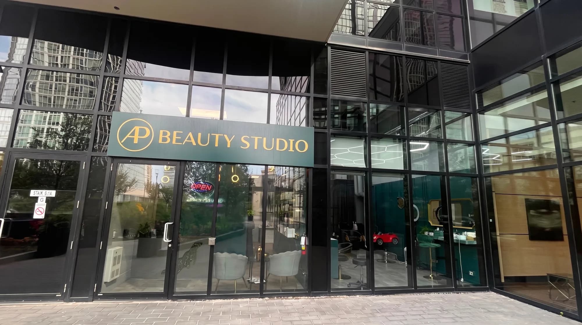 The AP Beauty Studio storefront in Vaughan, its teal and gold sign above a glass frontage looking into the salon